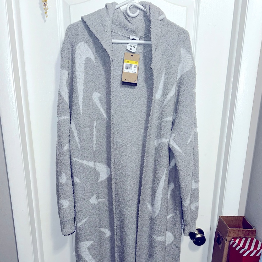 Brand new grey and white Nike sweater, size Small. Runs a little big.